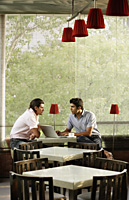 two men at laptop in cafe - Alex Mares-Manton