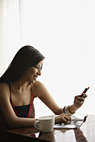 woman looking at text messages - Alex Mares-Manton