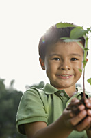 Little boy holding seedling tree - Yukmin