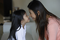 Mother and daughter touching noses - Yukmin
