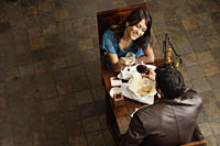 couple enjoying meal and drinks - Alex Mares-Manton