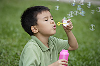 Boy blowing bubbles - Yukmin