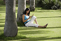 teen girl reading book in park - Alex Mares-Manton