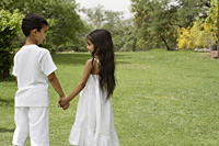 boy and girl holding hands in park - Alex Mares-Manton