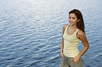 Young woman standing by a lake - Yukmin