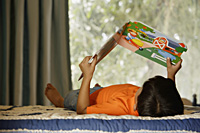 boy reading on bed - Alex Mares-Manton