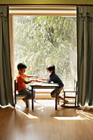 two little boys playing at table - Alex Mares-Manton