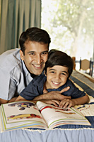 father and son reading book - Alex Mares-Manton