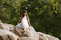 girl in white sari, sitting on rock - Alex Mares-Manton