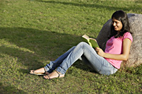 teen girl reading book in park - Alex Mares-Manton