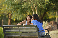 Two teen girls giggling in park - Alex Mares-Manton