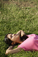 teen girl lying on back on grass - Alex Mares-Manton