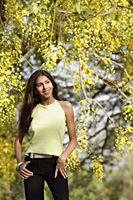 teen girl standing under blooming tree - Alex Mares-Manton