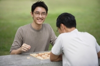 Two men playing Chinese chess in park - Yukmin