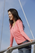 Young woman leaning over bridge - Yukmin