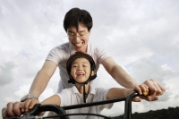 Father teaching son how to ride bike - Yukmin