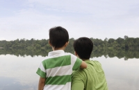 Father and son looking at lake - Yukmin
