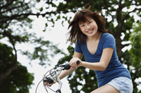 Young woman riding bike - Yukmin
