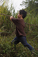 Boy running with stick. - Yukmin
