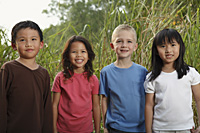 Four children standing together, smiling. - Yukmin