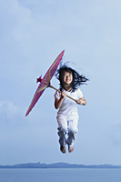 Young girl jumping with parasol - Yukmin