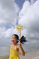 Young girl running with pinwheel. - Yukmin