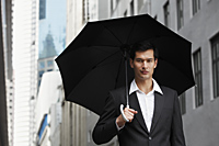 businessman holding umbrella - Yukmin