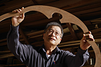 mature man looking at her creation - Nugene Chiang