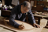 Carpenter working with wood. - Nugene Chiang