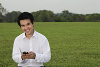 man in white shirt texting on phone and smiling - Yukmin