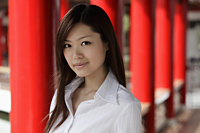 Head shot of Chinese woman in front of red pillars - Yukmin