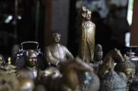 A display of bronze Chairmen Mao statues and other collectibles - Yukmin