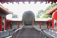 Old man with grey hair looking at Chinese Temple - Yukmin