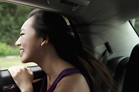 young woman leaning head out of the window smiling - Yukmin
