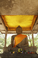 stone carving of Buddha wearing orange sash, Angkor Wat - Alex Mares-Manton