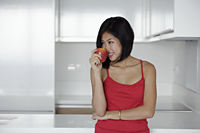 young woman smelling red apple - Yukmin