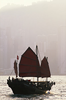 China,Hong Kong,Victoria Harbour,Junk and City Skyline in Background - Travelasia