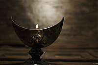 Silver cresent candle holder with lit candle - Alex Mares-Manton