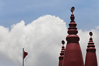 Red turrets of Hindu Temple with "OM" in Sanskrit on top - Alex Mares-Manton