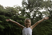 young girl with ams outstretched smiling at camera - Yukmin