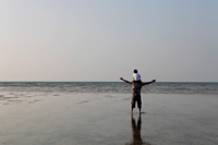 Son sitting on father's shoulders looking at the sea - Yukmin