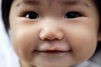 Close up of baby's face smiling - Yukmin