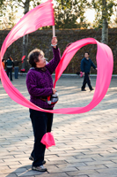 China,Beijing,Summer Palace Park,Woman Exercising with pink ribbon - Travelasia