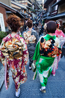 Rear view of women dressed in Kimonos walking down the street. Japan,Kyoto. - Travelasia