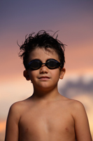 Head shot of young boy with goggles at sunset - Yukmin