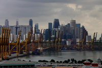 Shipping docks in front of Singapore city skyline. - Yukmin