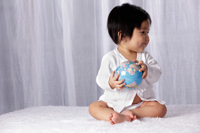 Chinese baby holding small globe - Yukmin