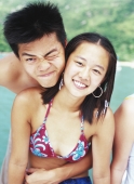 Teenage couple embracing, in swimwear - Jade Lee