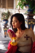 Thai woman holding flowers - John McDermott