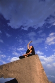 Woman doing Yoga outdoors - John McDermott